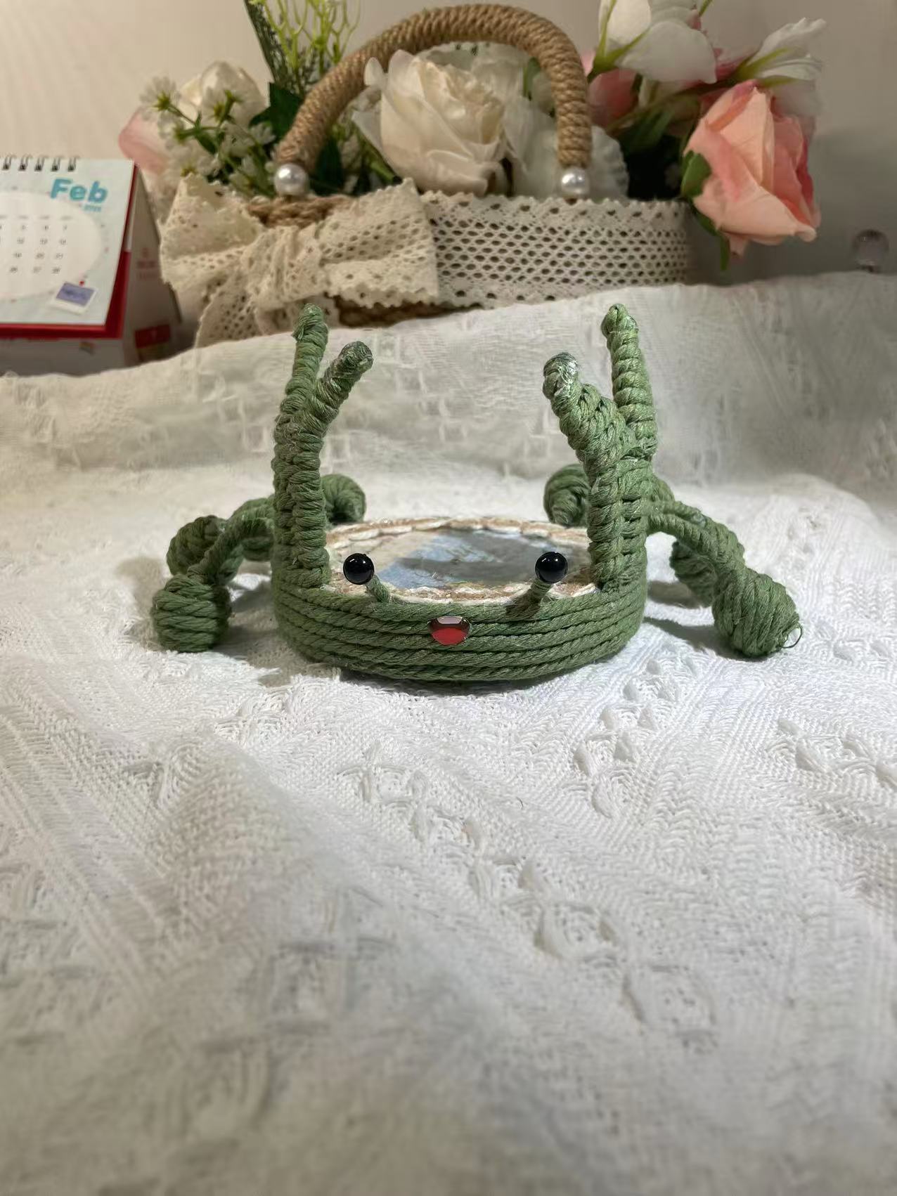 Handwoven crab-shaped phone holder