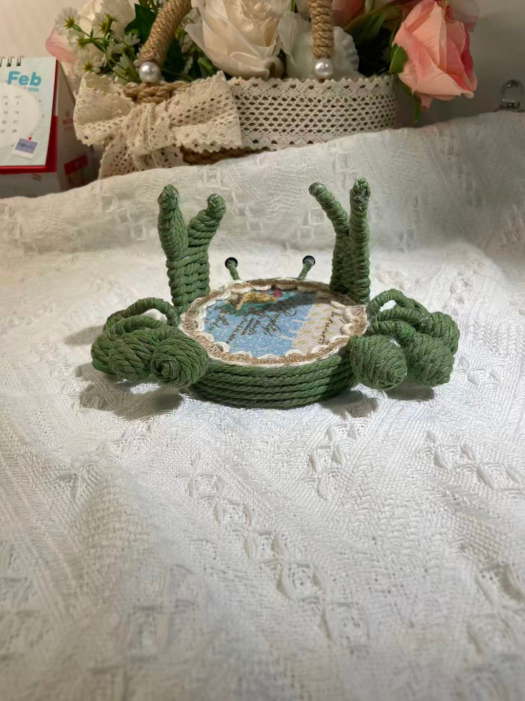 Handwoven crab-shaped phone holder